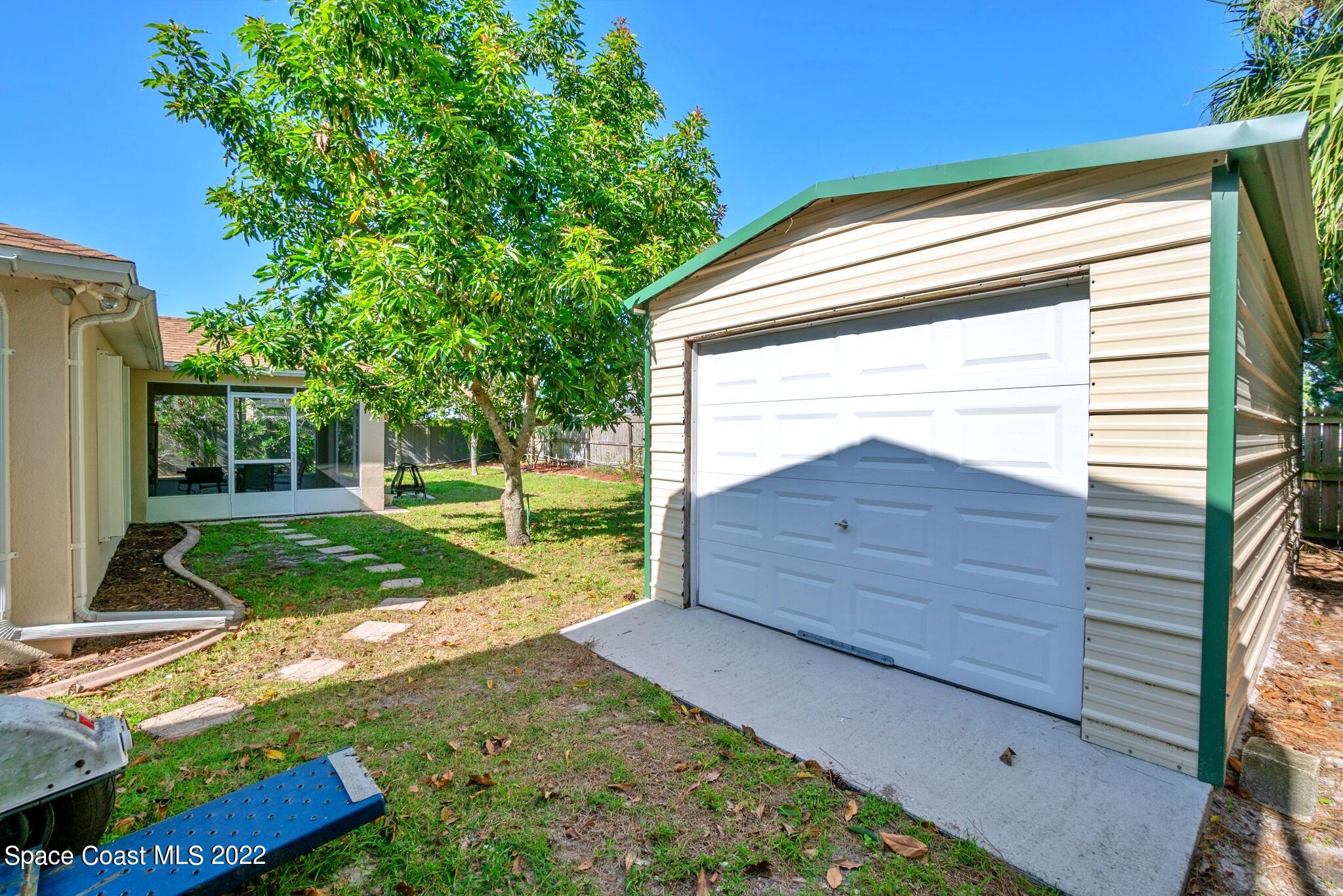 5449 Flint Road Cocoa, FL 32927 - Photo 33 of 36 a view of a backyard with a garden