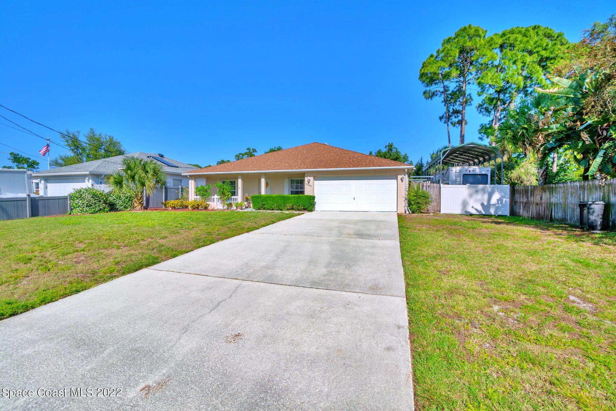 5449 Flint Road Cocoa, FL 32927 - Photo 4 of 36 a front view of a house with a yard
