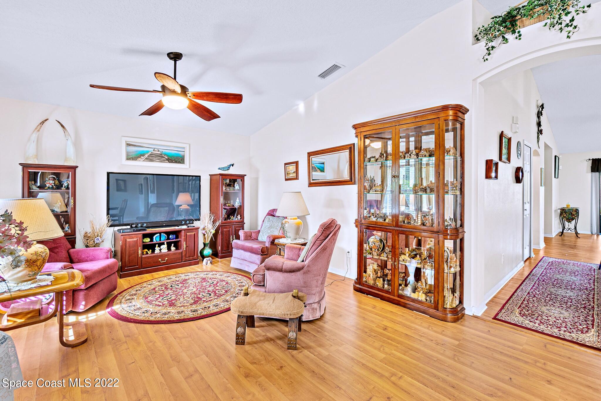 5449 Flint Road Cocoa, FL 32927 - Photo 8 of 36 a living room with furniture windows and a wooden floor