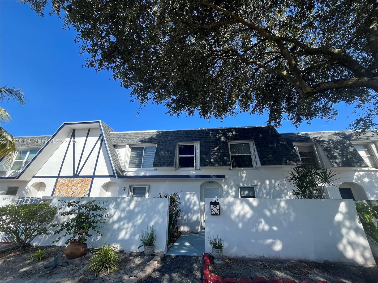 3924 Southwest 67th Terrace, Unit 117 Davie, FL 33314 - Photo 1 of 18 a front view of a house with a yard