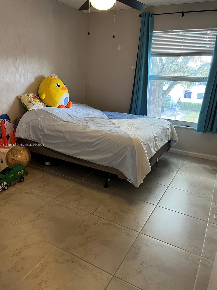 3924 Southwest 67th Terrace, Unit 117 Davie, FL 33314 - Photo 11 of 18 a bedroom with a bed and a window