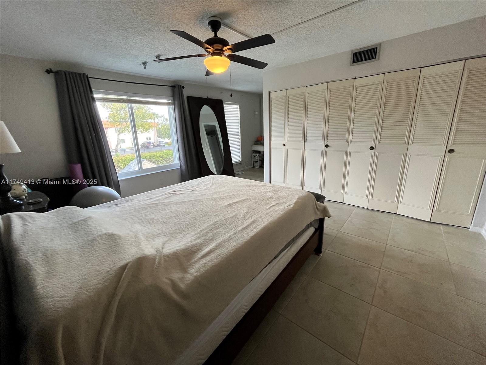 3924 Southwest 67th Terrace, Unit 117 Davie, FL 33314 - Photo 12 of 18 a bedroom with a bed and a window