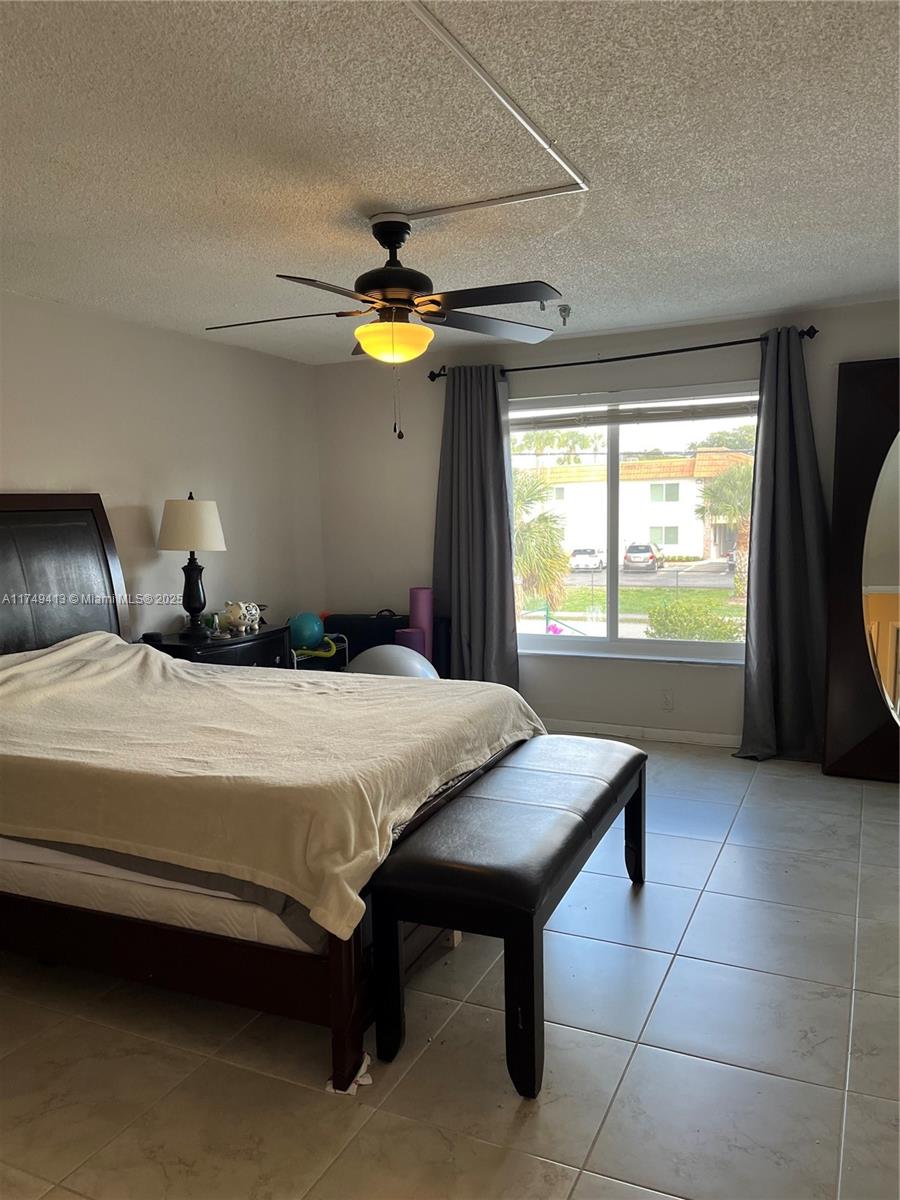3924 Southwest 67th Terrace, Unit 117 Davie, FL 33314 - Photo 15 of 18 a bedroom with a bed and a window