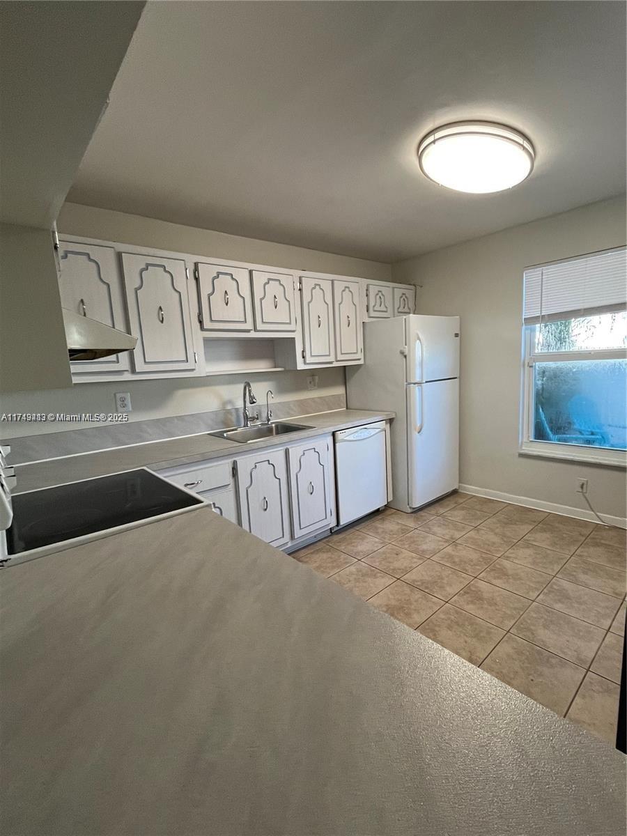 3924 Southwest 67th Terrace, Unit 117 Davie, FL 33314 - Photo 18 of 18 a view of kitchen with cabinets and refrigerator