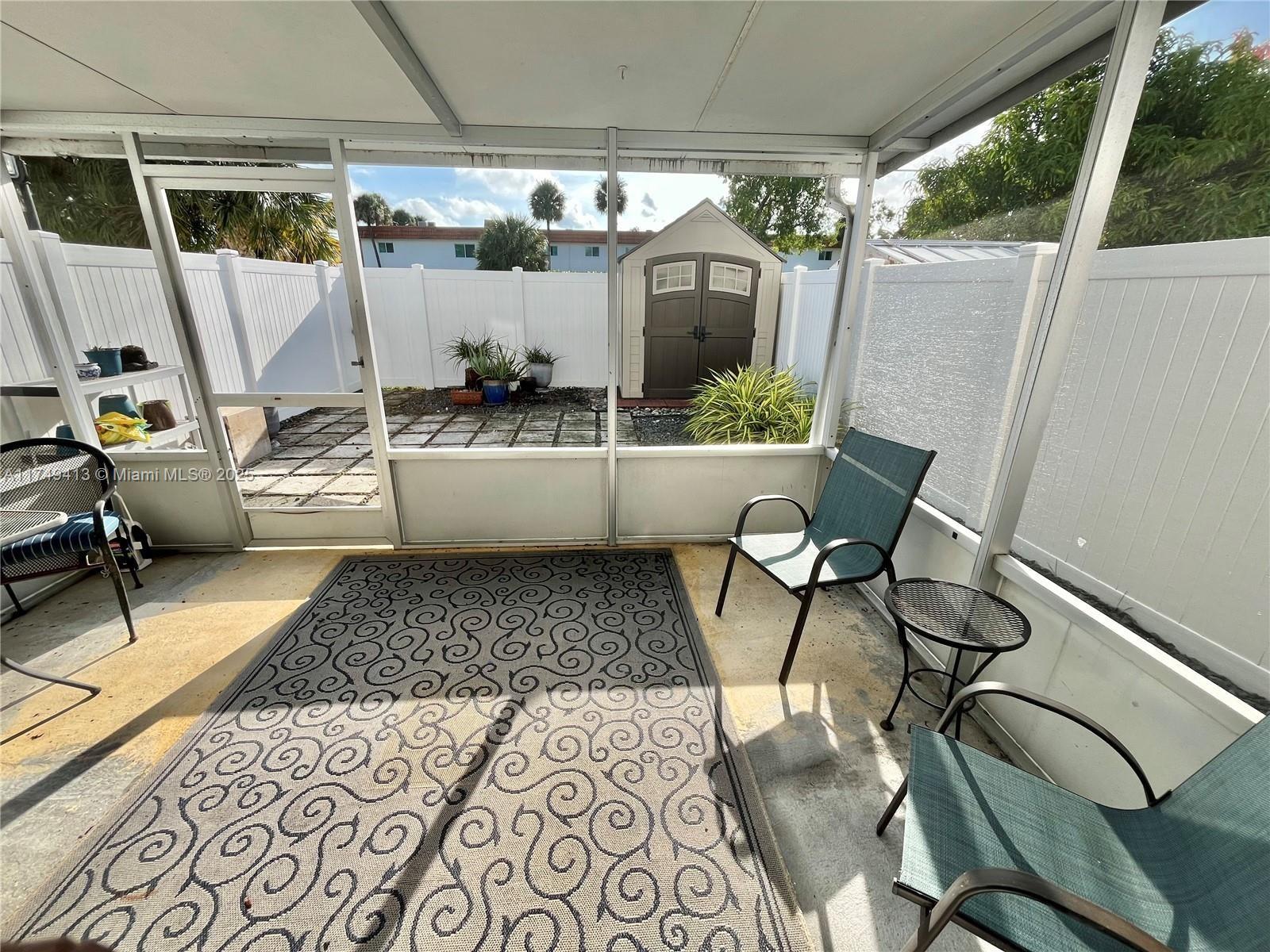 3924 Southwest 67th Terrace, Unit 117 Davie, FL 33314 - Photo 2 of 18 a view of a chairs and table in a patio