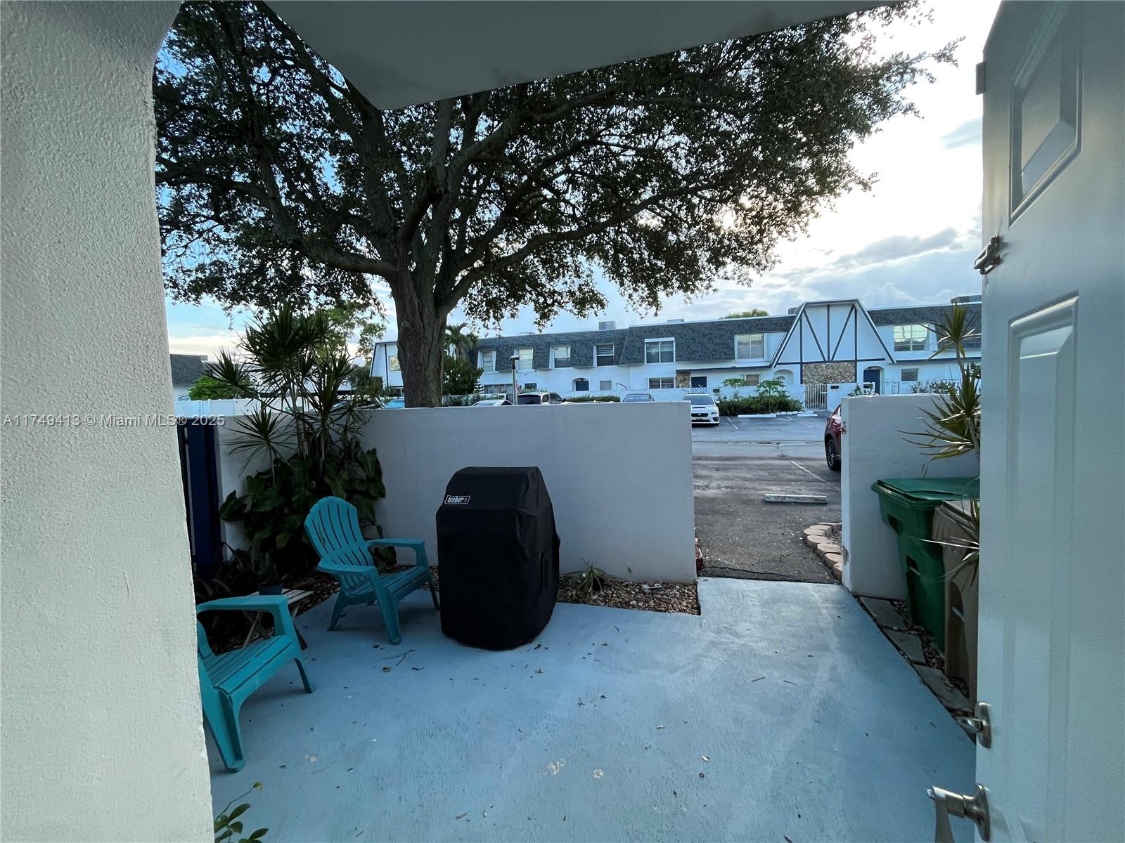 3924 Southwest 67th Terrace, Unit 117 Davie, FL 33314 - Photo 3 of 18 a view of a chairs and table in backyard room