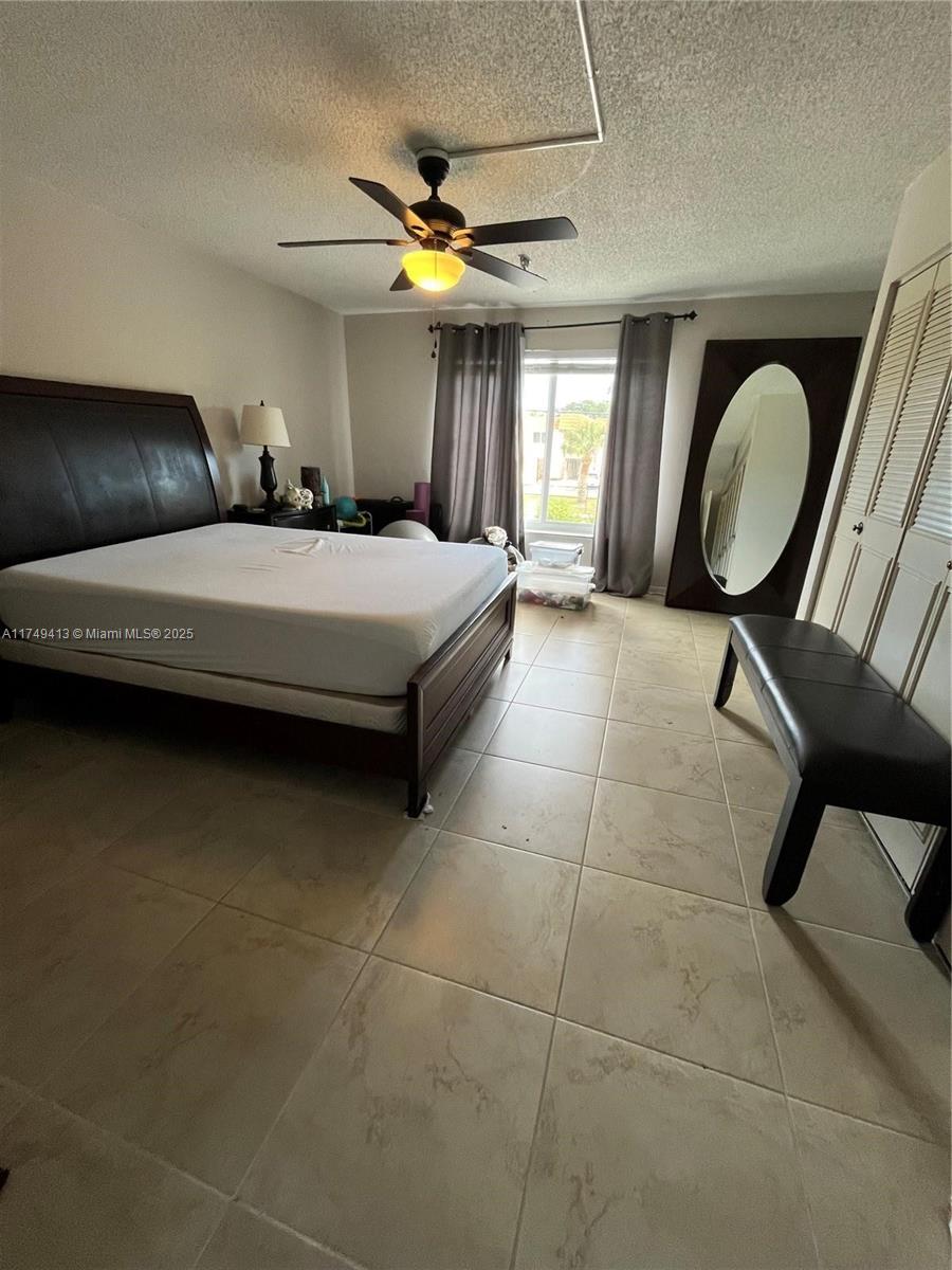 3924 Southwest 67th Terrace, Unit 117 Davie, FL 33314 - Photo 6 of 18 a bedroom with a bed and a chandelier