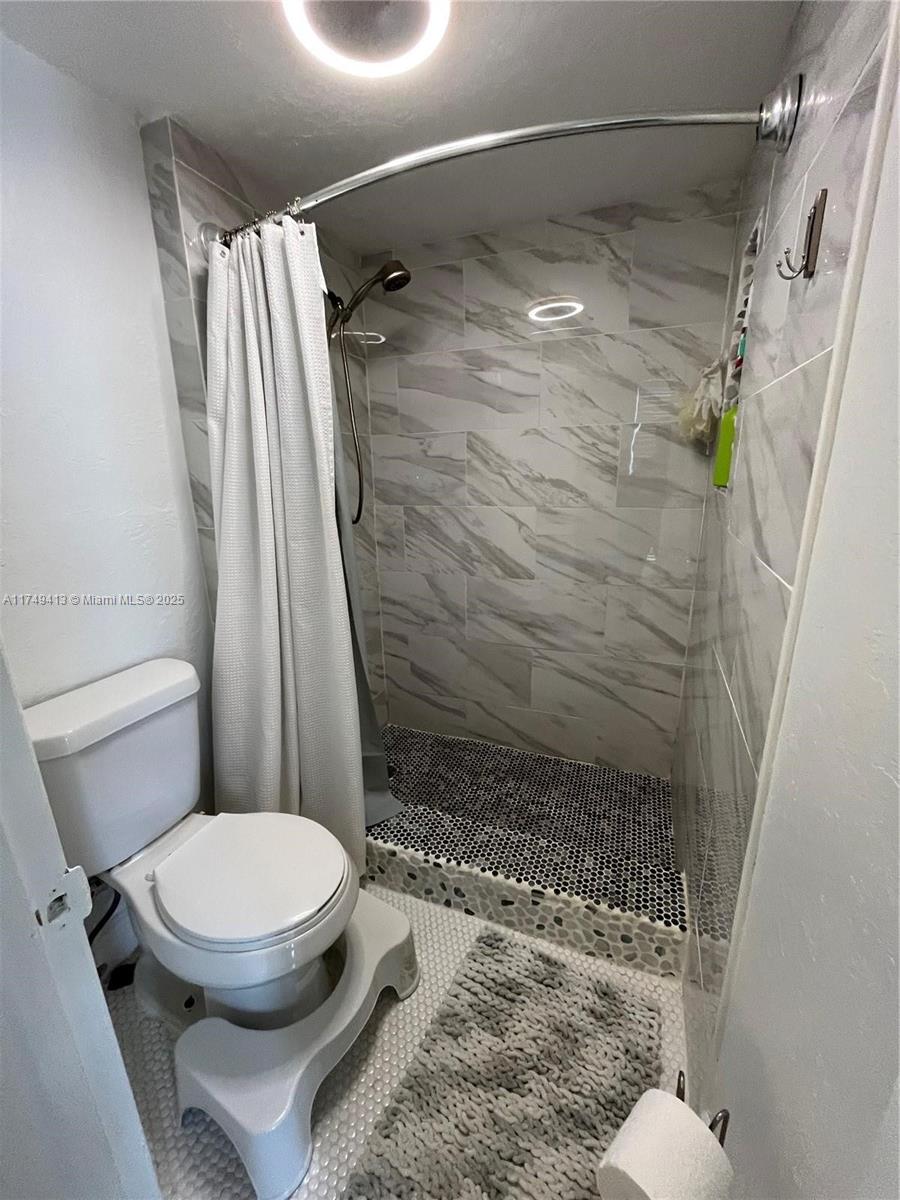 3924 Southwest 67th Terrace, Unit 117 Davie, FL 33314 - Photo 8 of 18 a bathroom with a toilet and shower