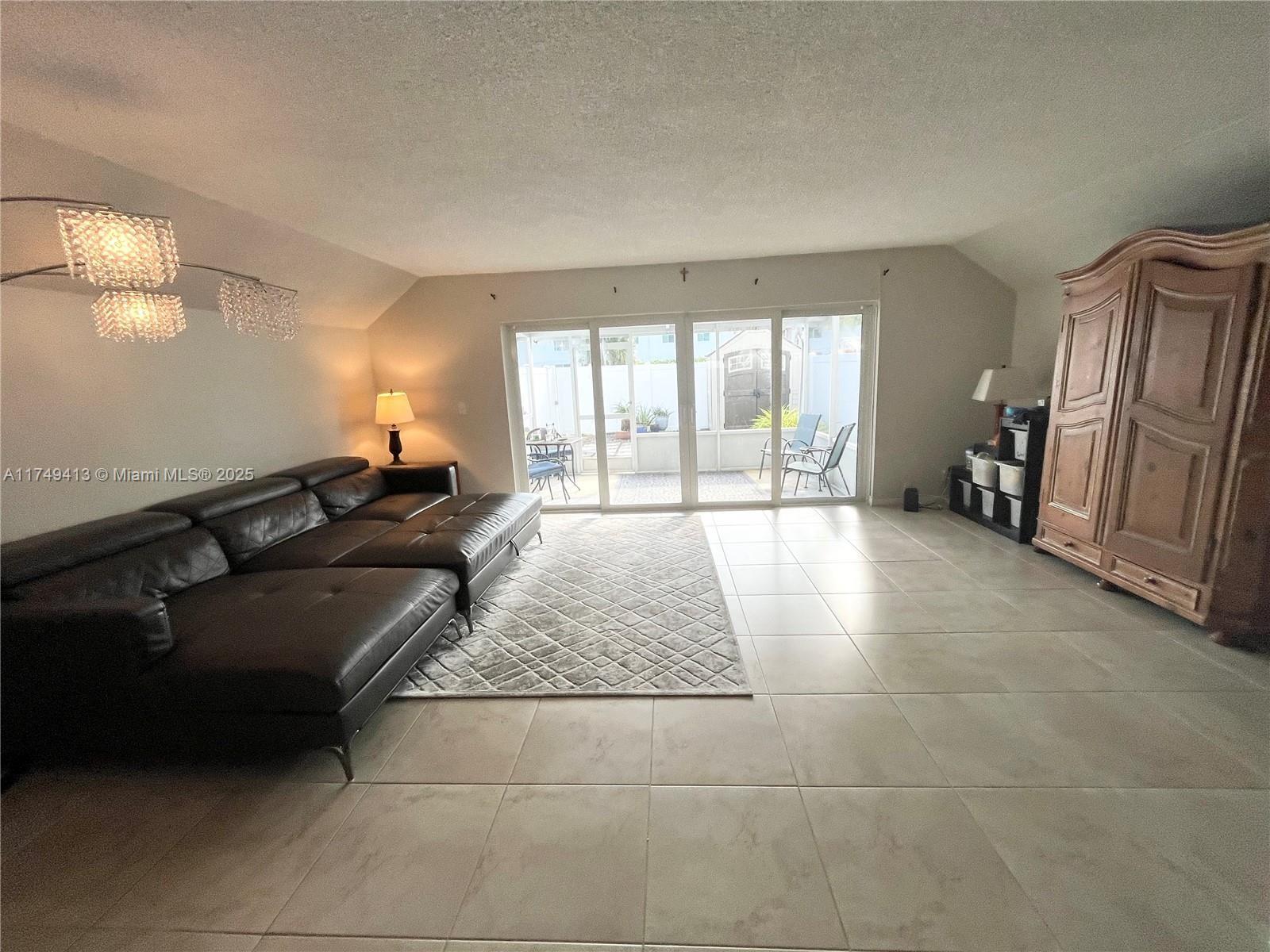 3924 Southwest 67th Terrace, Unit 117 Davie, FL 33314 - Photo 9 of 18 a living room with a couch and a large window