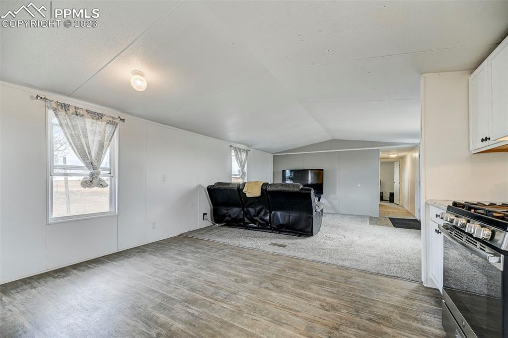 35525 Fossinger Road Yoder, CO 80864 - Photo 14 of 38 a living room with furniture and a flat screen tv