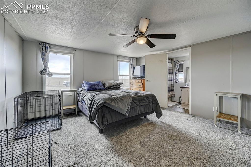 35525 Fossinger Road Yoder, CO 80864 - Photo 17 of 38 a bedroom with a bed and a chandelier