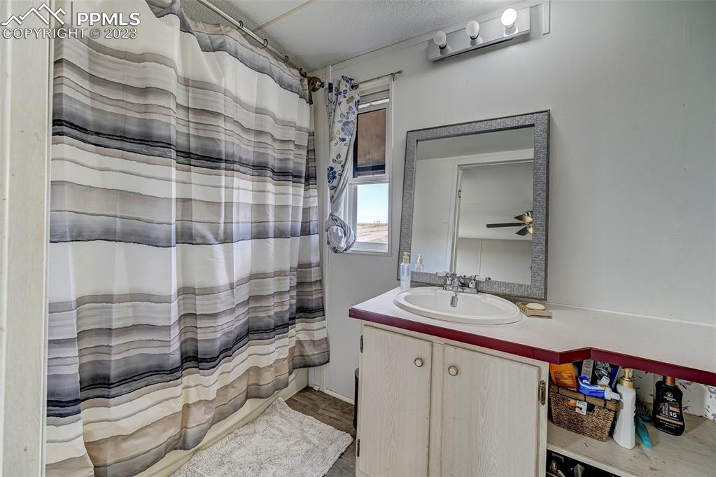 35525 Fossinger Road Yoder, CO 80864 - Photo 20 of 38 a bathroom with a sink and a mirror
