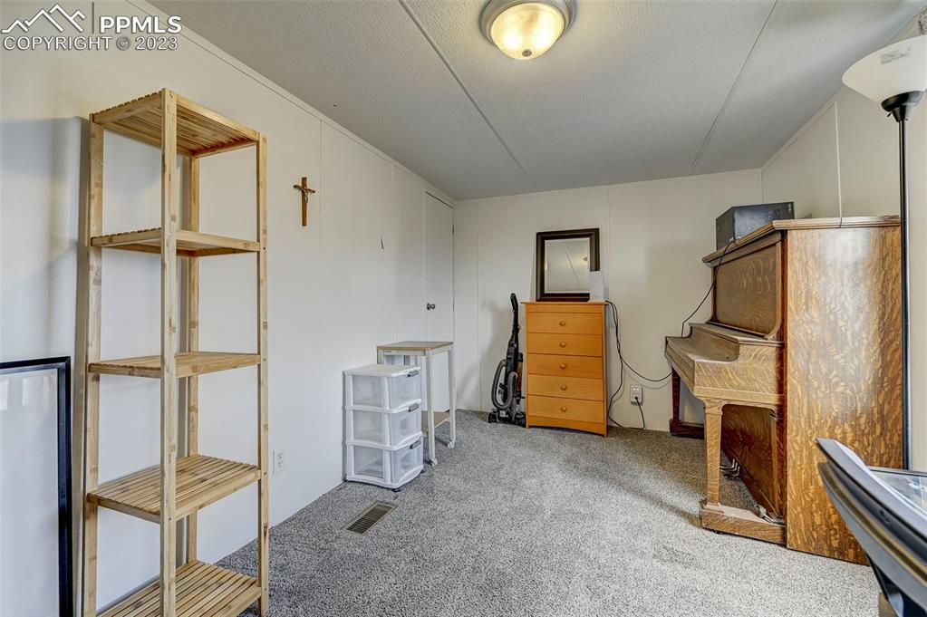35525 Fossinger Road Yoder, CO 80864 - Photo 25 of 38 a room with wooden floor and furniture