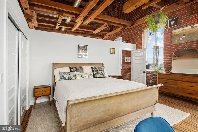 a bedroom with a bed and a large window