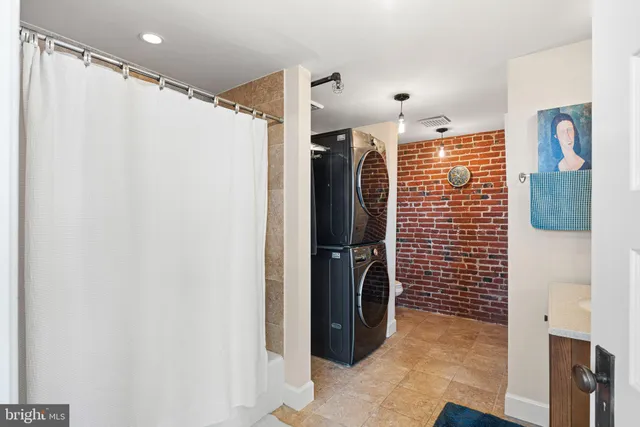 a bathroom with a sink a mirror and shower