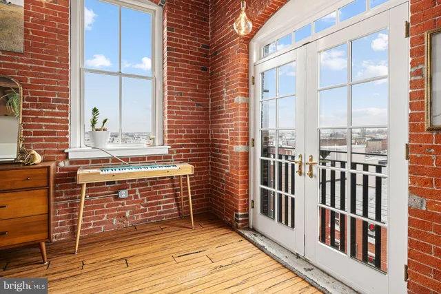 a room with pool table and a large window