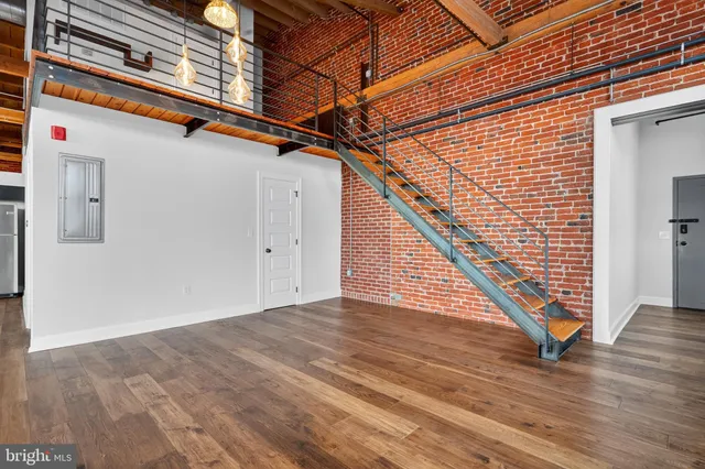 a view of an empty room with wooden floor