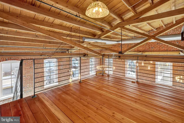 a view of a balcony with wooden floor