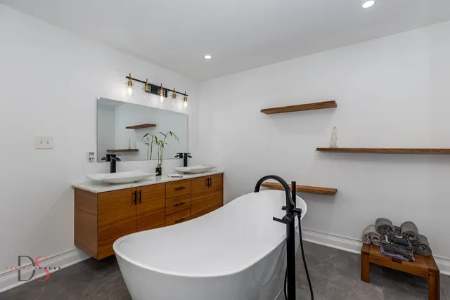 a white bath tub sitting next to a white toilet