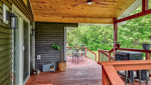 a view of a swimming pools with large trees in the back