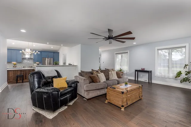 a living room with furniture and a wooden floor