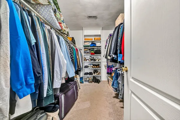 a living room with furniture staircase and a large window