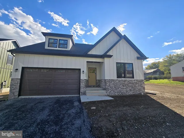 a view of a house with a yard and garage