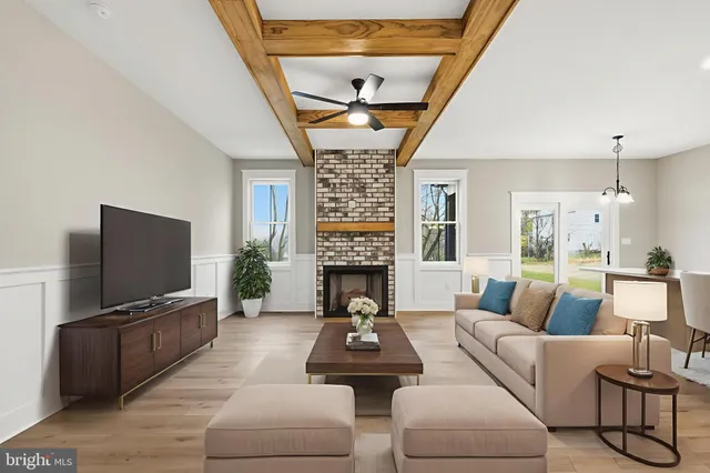 a living room with furniture a fireplace and a flat screen tv