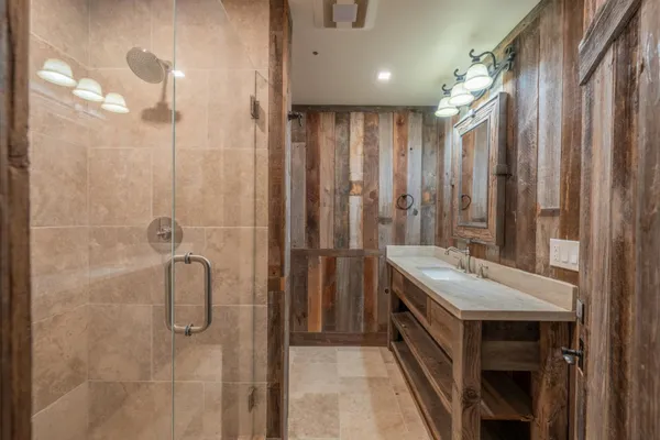 a bathroom with a double vanity sink toilet and shower