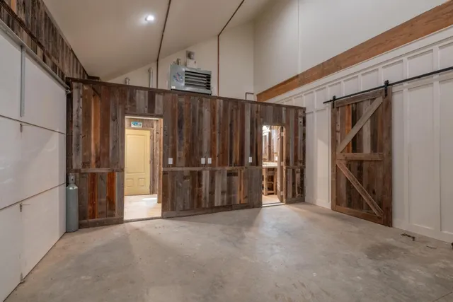 a view of empty room with wooden walls