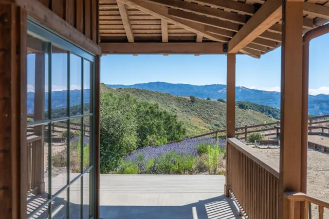 a view of a balcony with yard