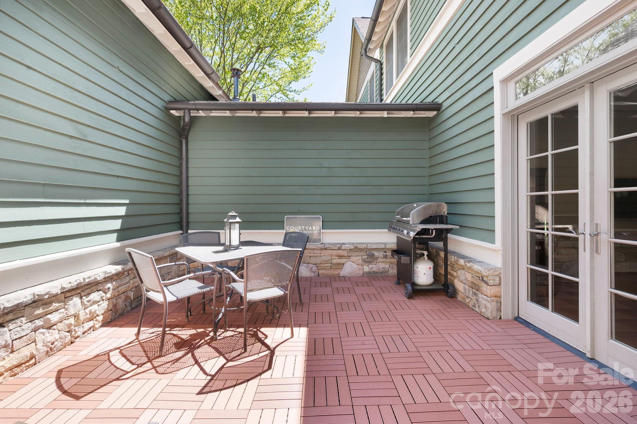 4 Fitzgerald Road Black Mountain, NC 28711 - Photo 14 of 43 a view of a patio with table and chairs with wooden floor and fence