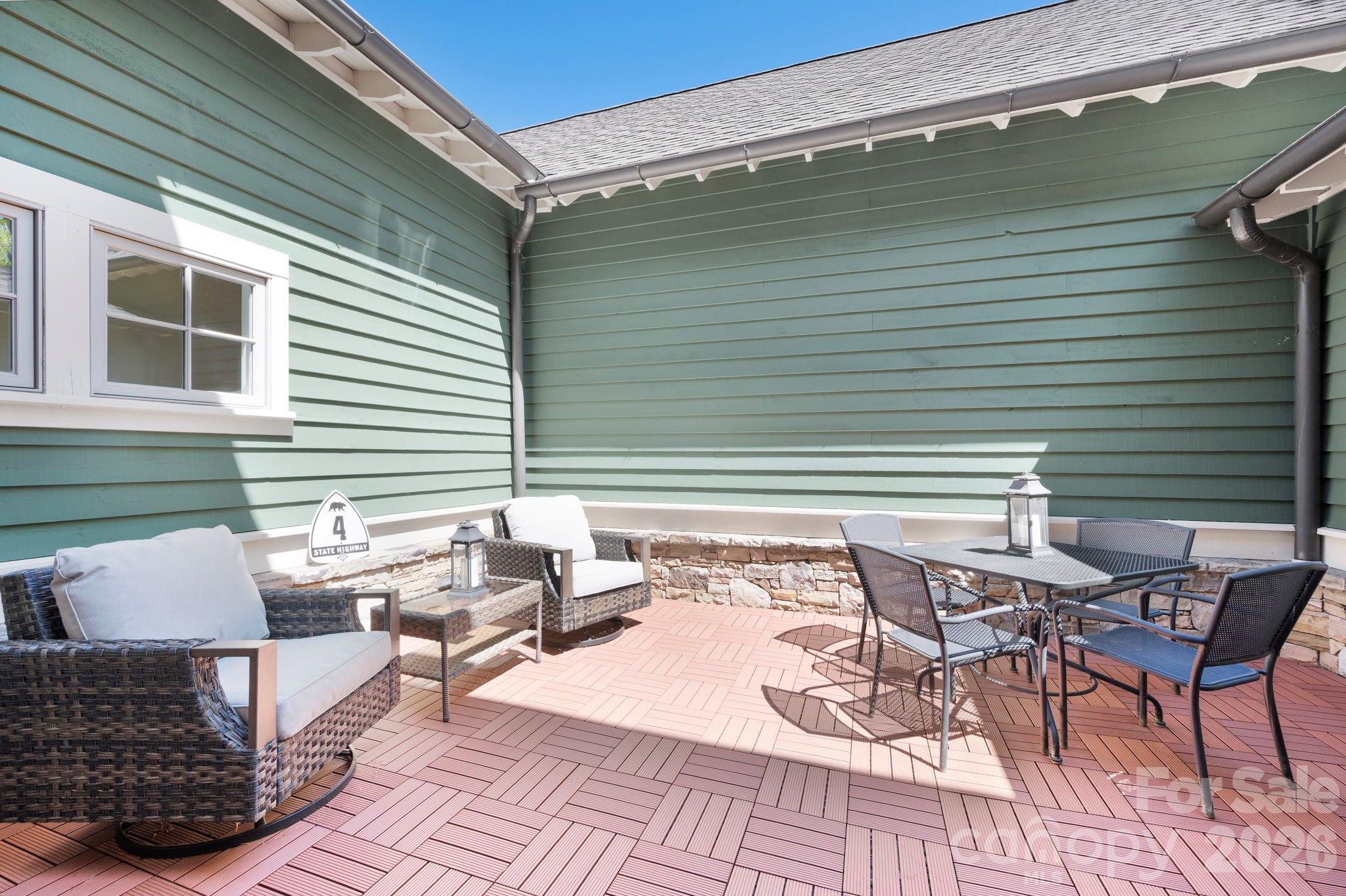 4 Fitzgerald Road Black Mountain, NC 28711 - Photo 15 of 43 a roof deck with a table and chairs and potted plants