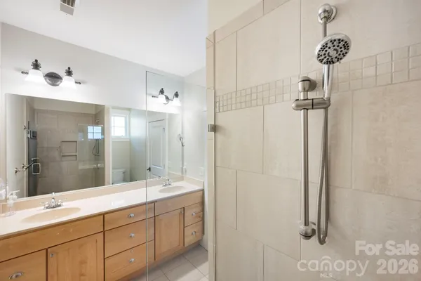 a bathroom with a shower sink and mirror