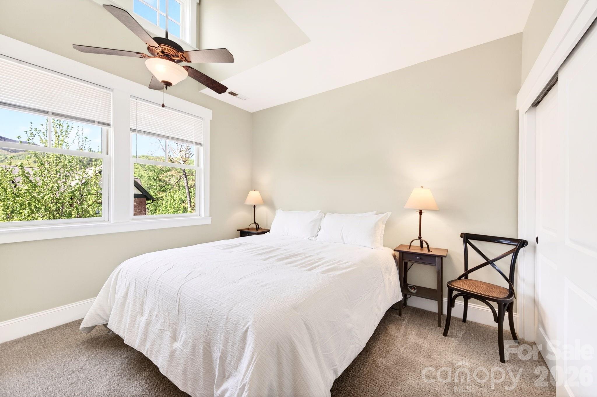 4 Fitzgerald Road Black Mountain, NC 28711 - Photo 18 of 43 a bedroom with a bed a chandelier and a window