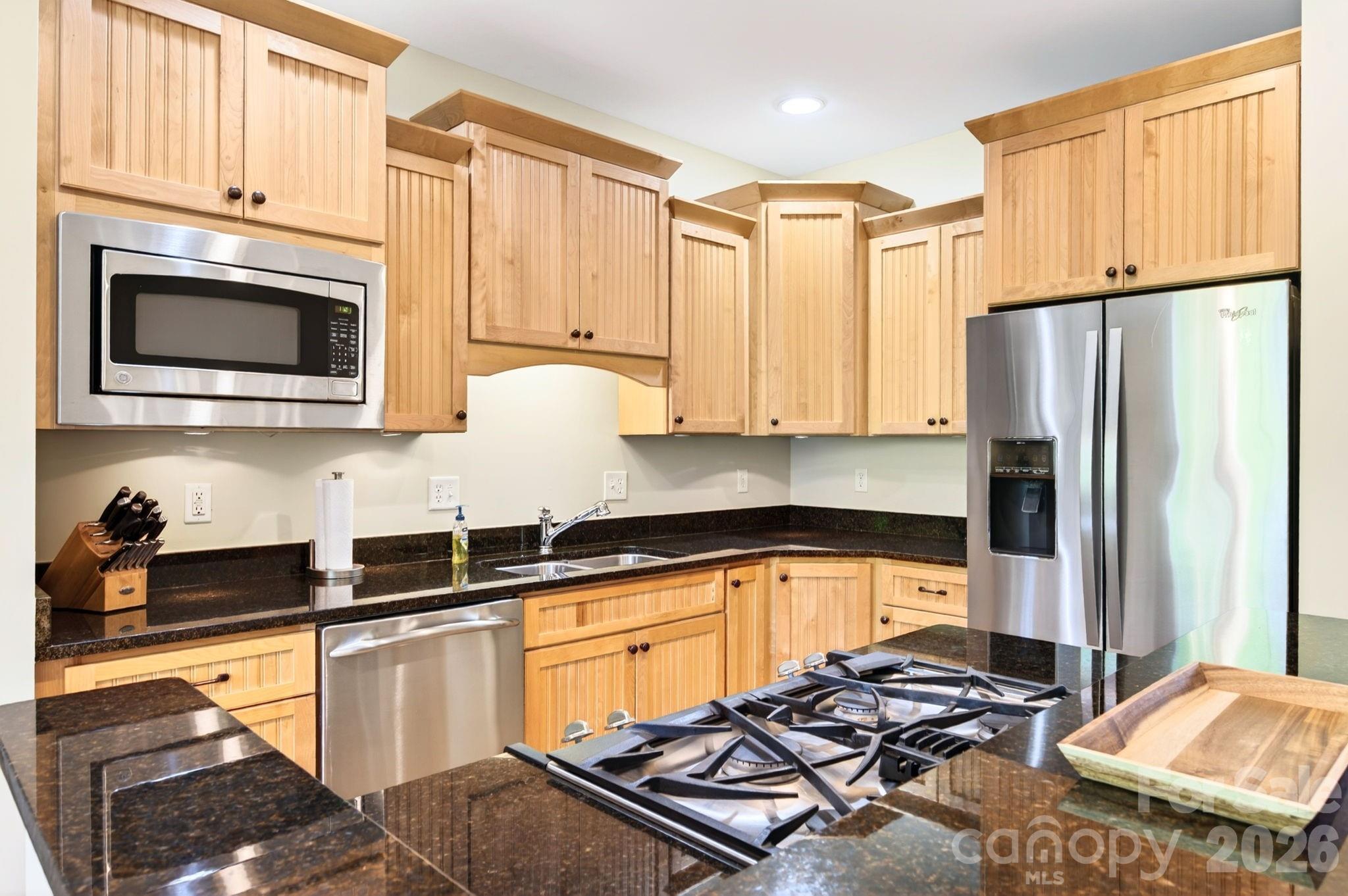 4 Fitzgerald Road Black Mountain, NC 28711 - Photo 10 of 43 a kitchen with stainless steel appliances wooden cabinets and a stove top oven