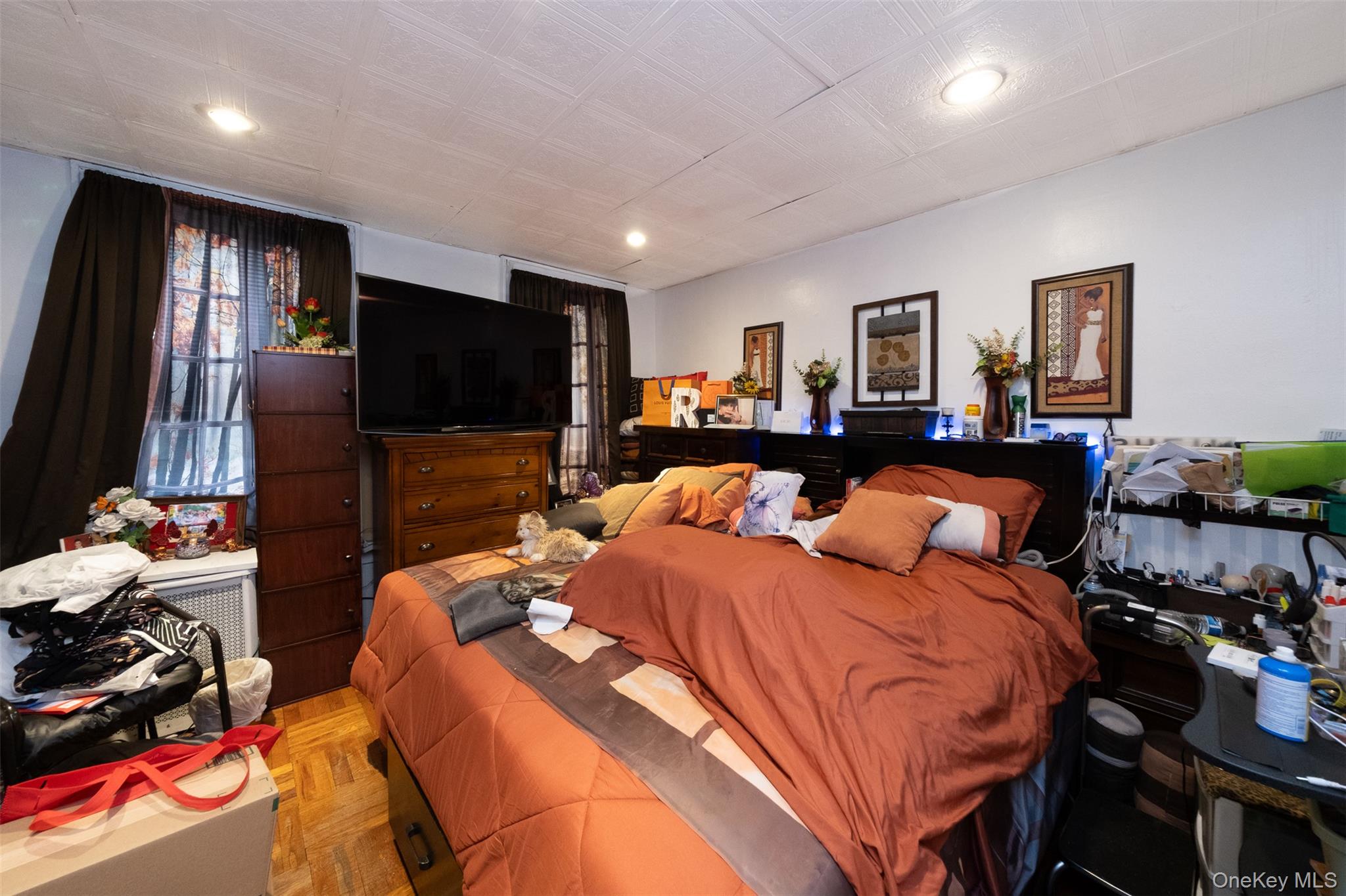 2541 Holland Avenue Bronx, NY 10467 - Photo 4 of 16 a bedroom with a bed and a flat screen tv