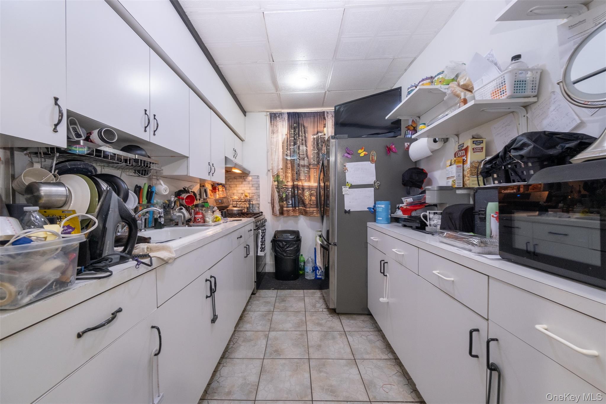 2541 Holland Avenue Bronx, NY 10467 - Photo 6 of 16 a kitchen with refrigerator and cabinets