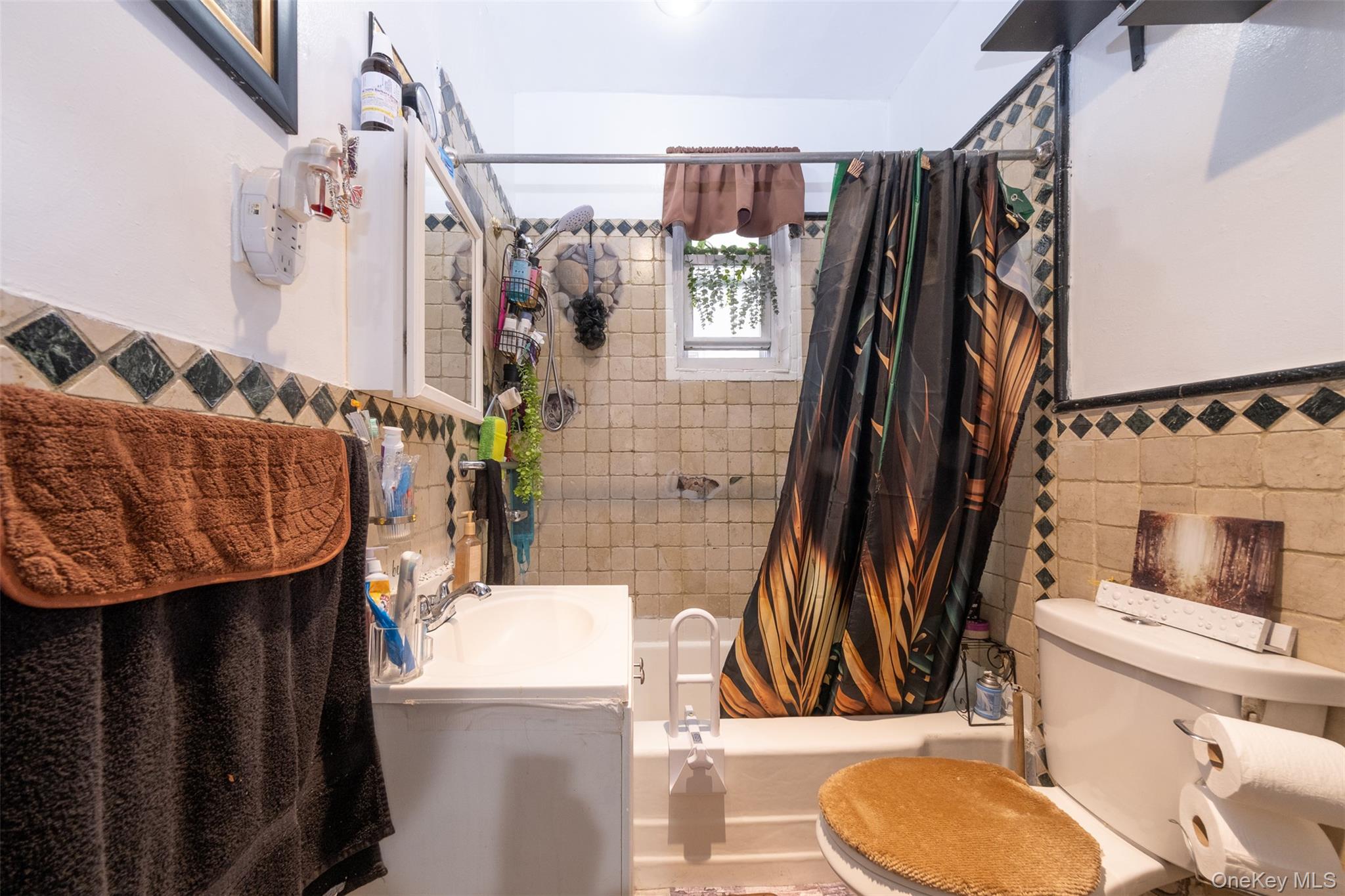 2541 Holland Avenue Bronx, NY 10467 - Photo 7 of 16 a bathroom with a sink toilet and shower