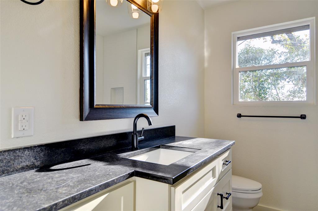 5549 Sam Calloway Road Fort Worth, TX 76114 - Photo 27 of 31 a bathroom with a granite countertop sink and a toilet