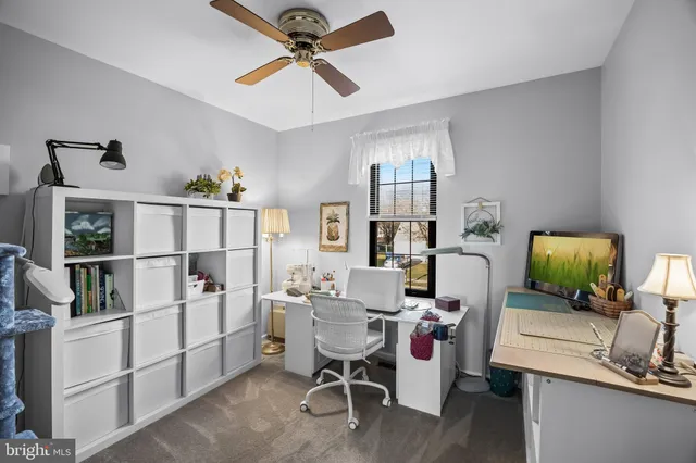 a bathroom with a granite countertop sink a mirror a toilet and shower