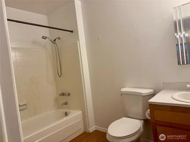 a white toilet sitting next to a bath tub and shower