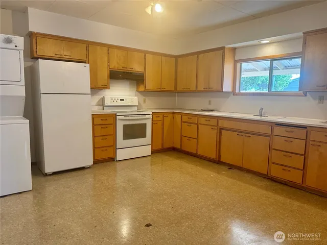 a kitchen with sink cabinets and refrigerator