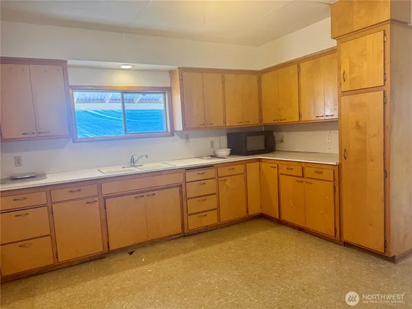 a kitchen with sink cabinets and window