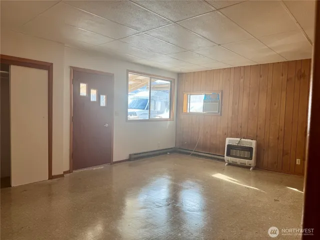 an empty room with windows and closet