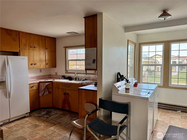 a kitchen with sink cabinets and refrigerator