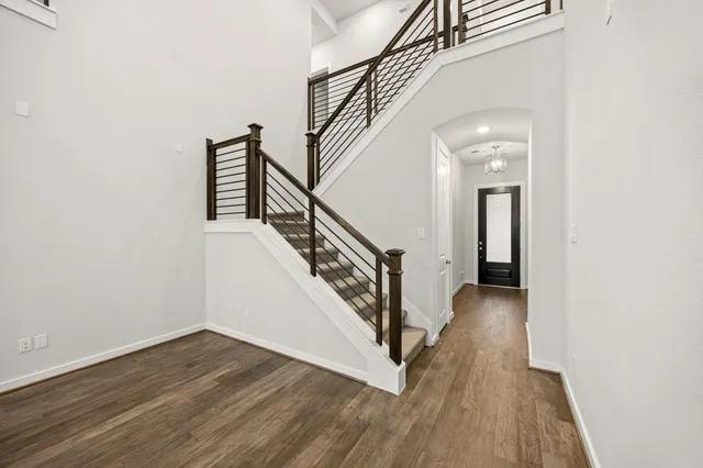 a view of a hallway with wooden floor and entryway