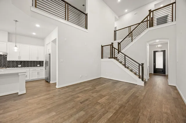 a view of entryway and hall with wooden floor