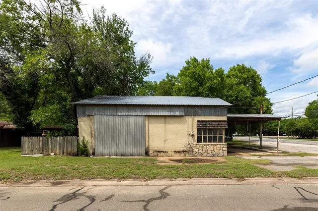 a backyard of a house with table and chairs