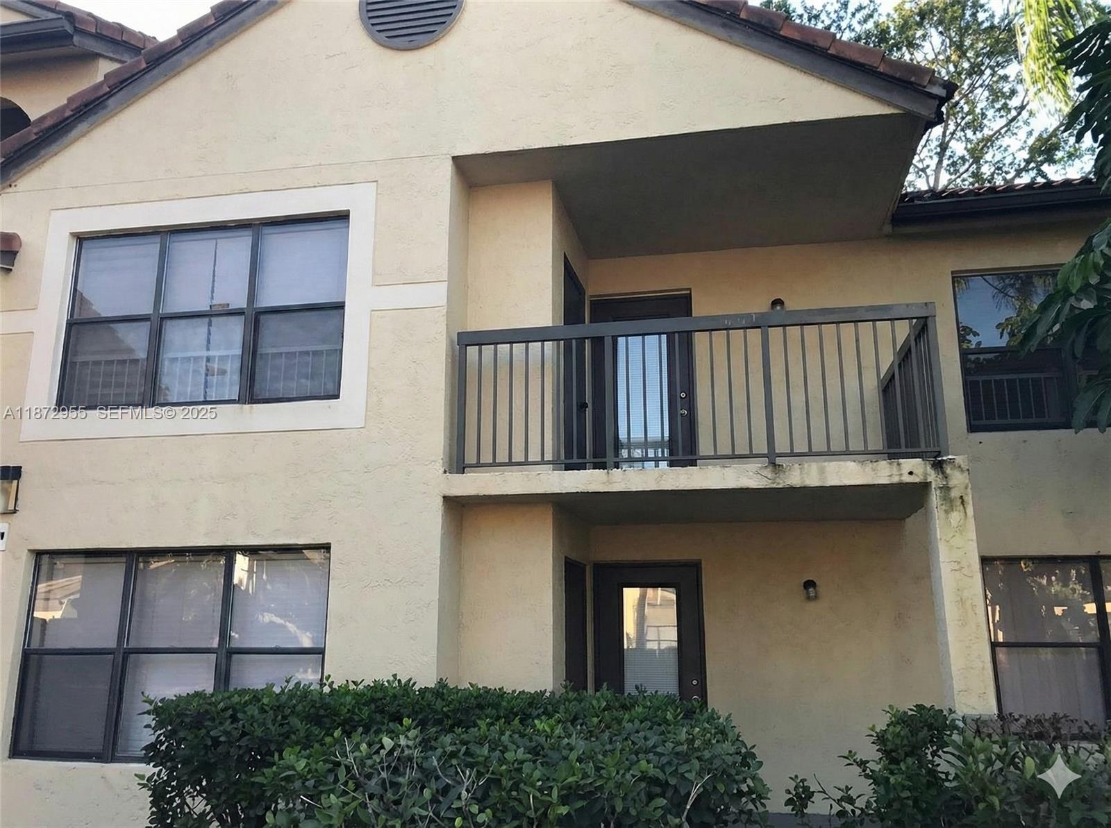 4201 West McNab Road, Unit 27 Pompano Beach, FL 33069 - Photo 1 of 15 a front view of a house with a garden